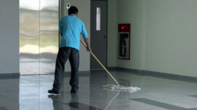 janitor cleaning commercial building floor